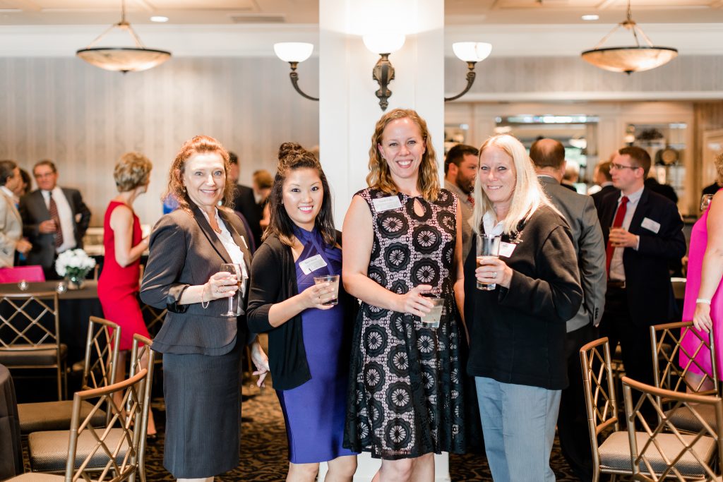 Hale Skemp staff members smile celebrate the 100th anniversary.