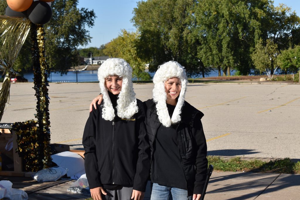 two people wearing white barrister wigs