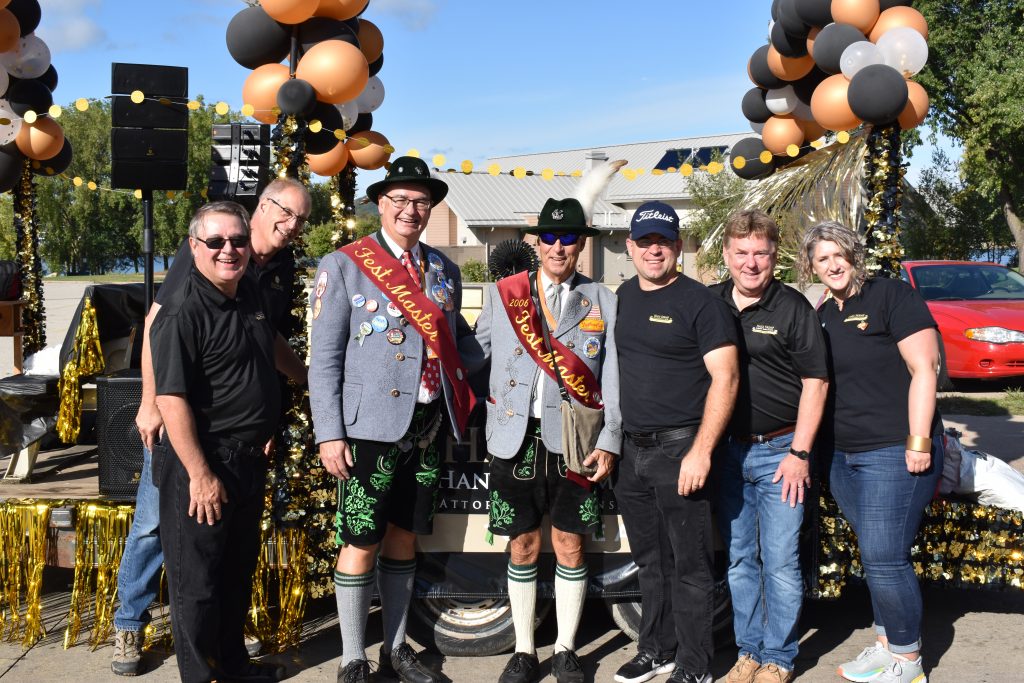 Members of the Hale Skemp team stand with festmasters in front of the Hale Skemp parade float.