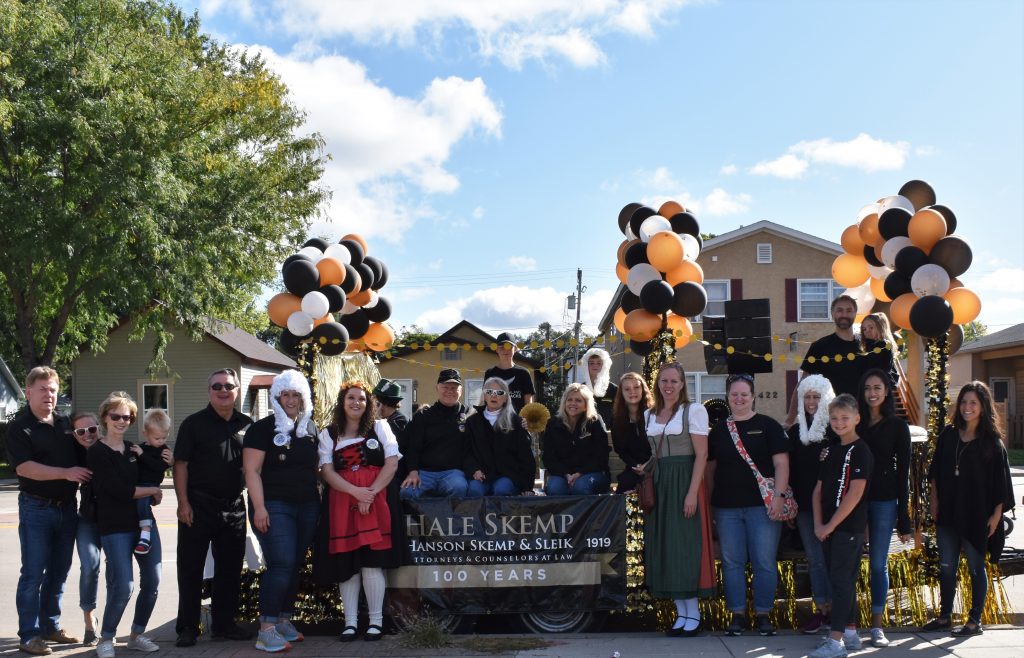 Group of people pose with parade float.