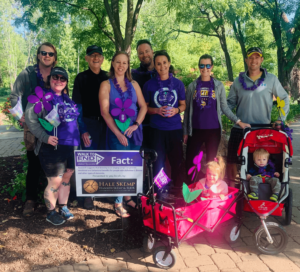 Hale Skemp team members, friends, and family stand near the Hale Skemp sign at the 2021 Walk to End Alz