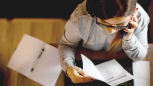 An overhead view of a woman looking at paperwork.