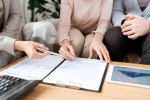 attorney explaining to mature clients where to sign document