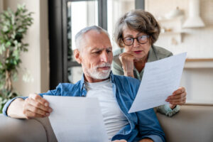 Man and woman review papers together